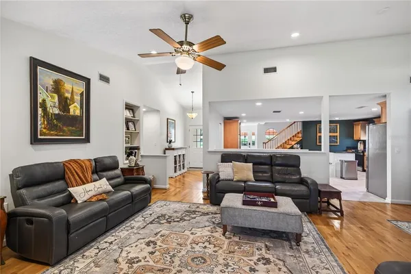 a kitchen with stainless steel appliances kitchen island granite countertop a refrigerator and a stove top oven