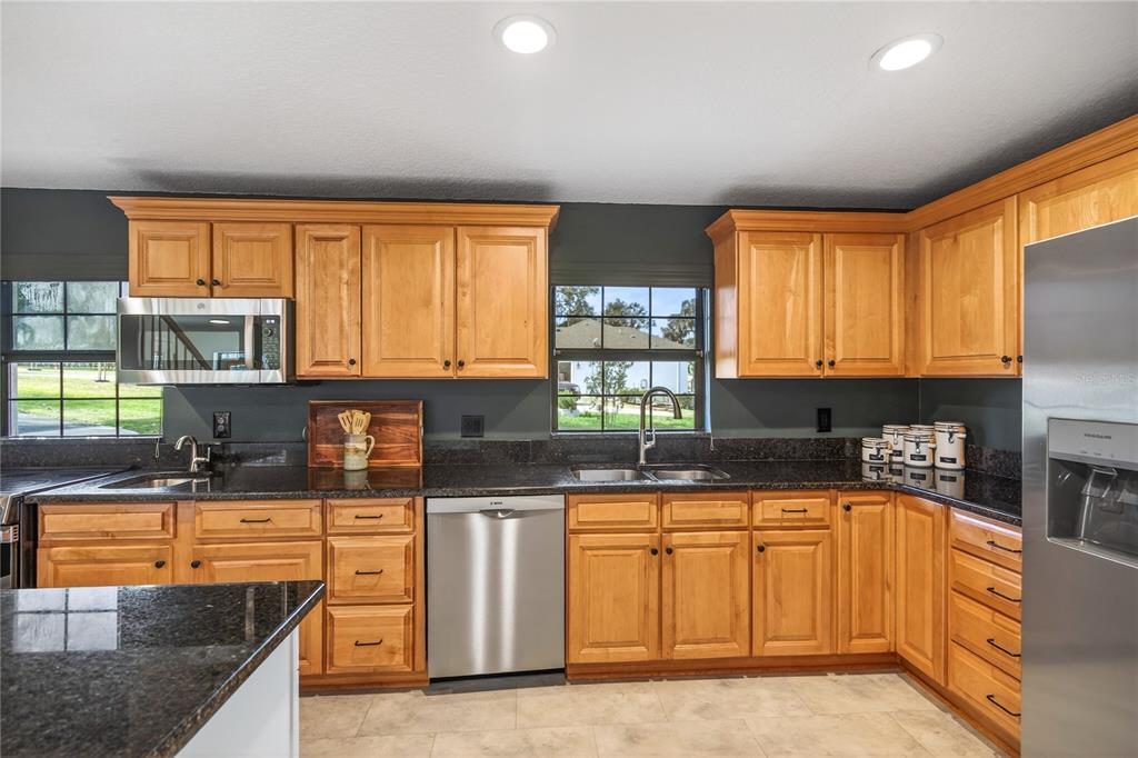 17025 Peru Road Umatilla, FL 32784 - Photo 21 of 73 a kitchen with granite countertop a sink a stove cabinets and counter space