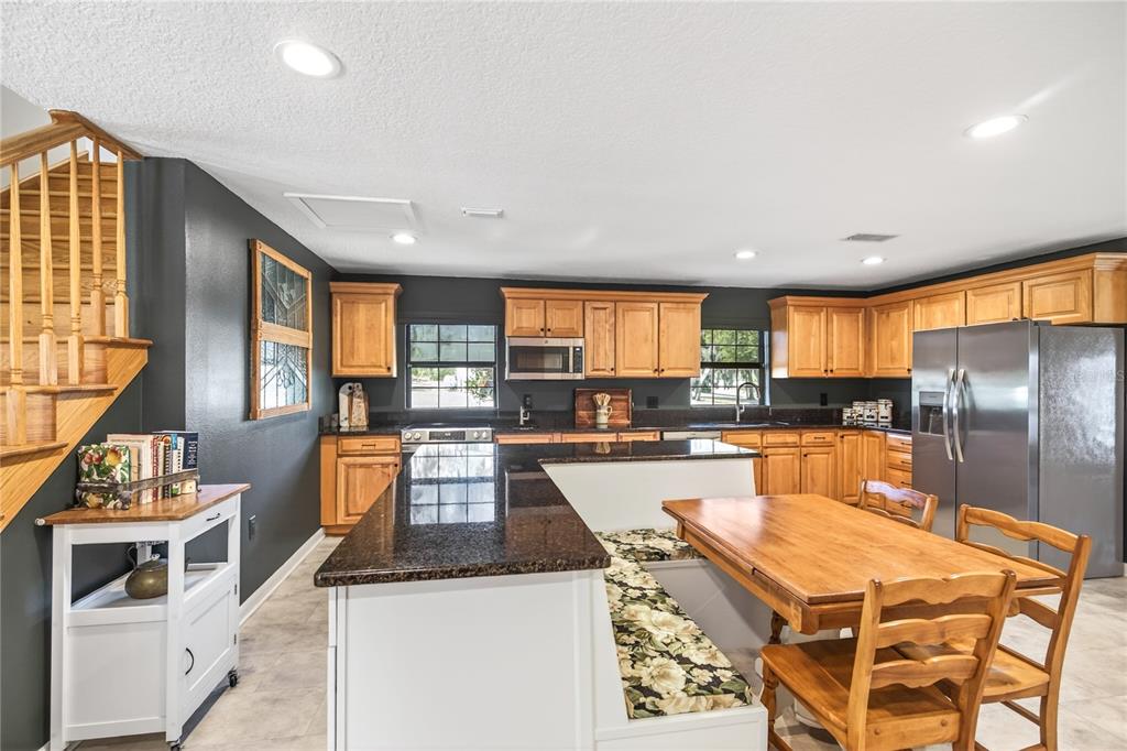 17025 Peru Road Umatilla, FL 32784 - Photo 24 of 73 a kitchen with stainless steel appliances granite countertop a stove top oven a sink dishwasher and cabinets with wooden floor