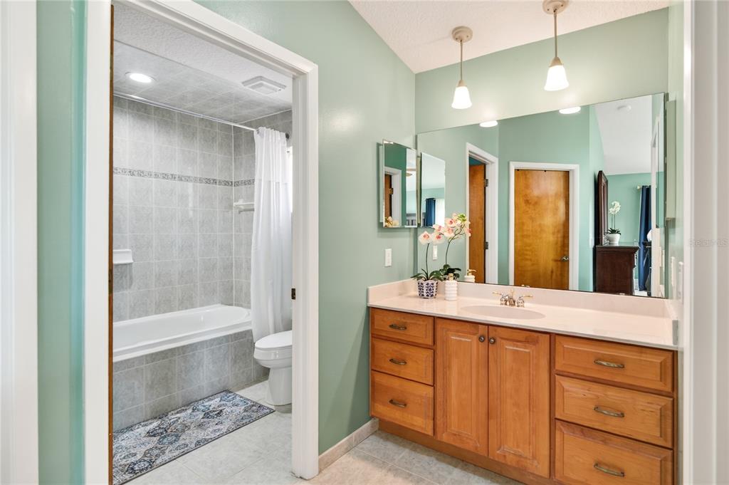17025 Peru Road Umatilla, FL 32784 - Photo 30 of 73 a bathroom with a double vanity sink toilet mirror and bathtub