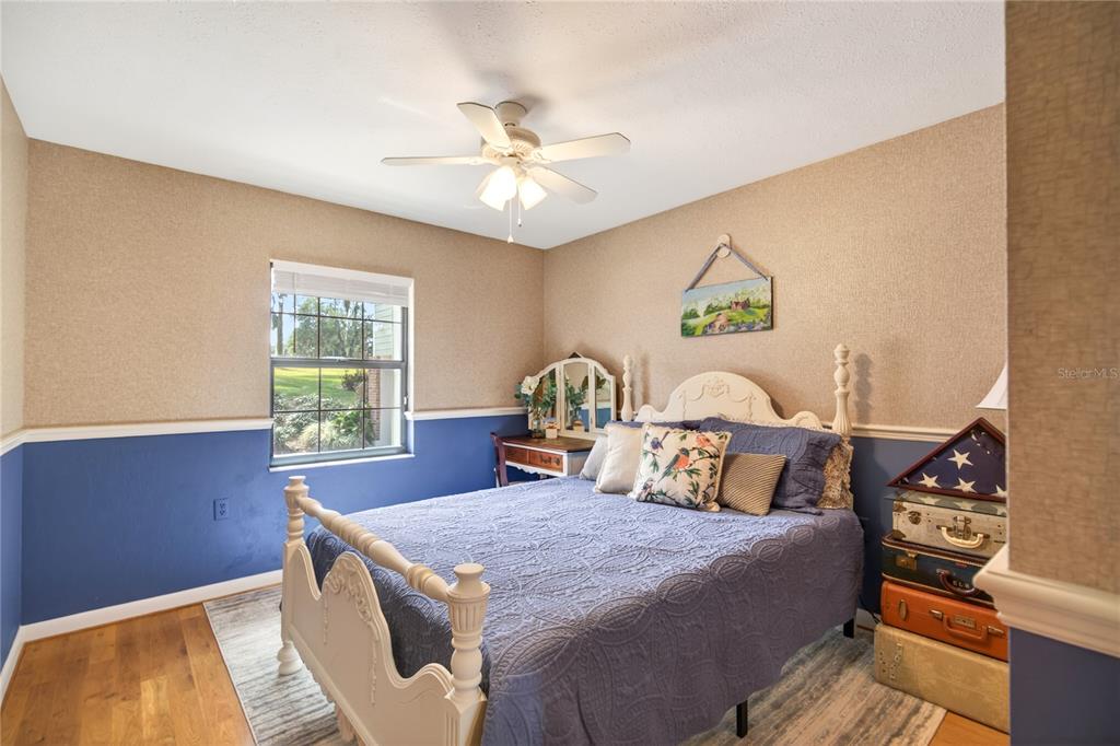 17025 Peru Road Umatilla, FL 32784 - Photo 35 of 73 a bedroom with a bed and a chandelier