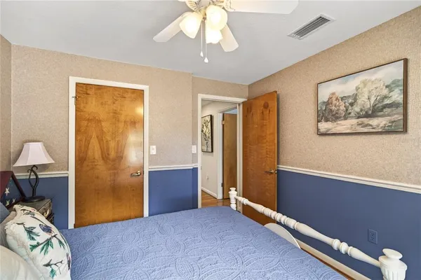 a bed room with a bed and a chair