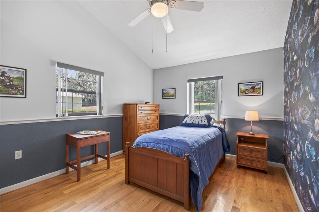 17025 Peru Road Umatilla, FL 32784 - Photo 37 of 73 a bedroom with a bed and a chandelier