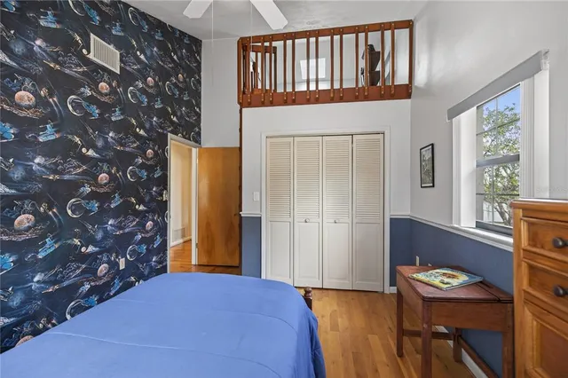 a bed room with a bed and a chair