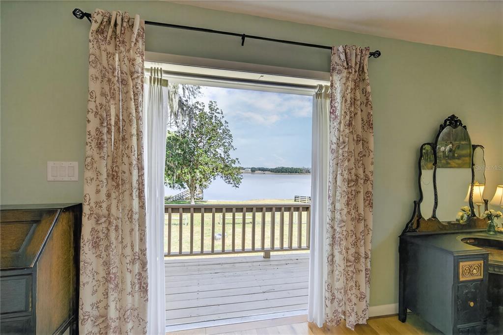 17025 Peru Road Umatilla, FL 32784 - Photo 44 of 73 a view of a porch with a wooden floor and a potted plant