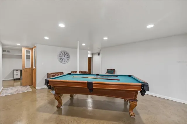 an aerial view of a house with a yard and lake view