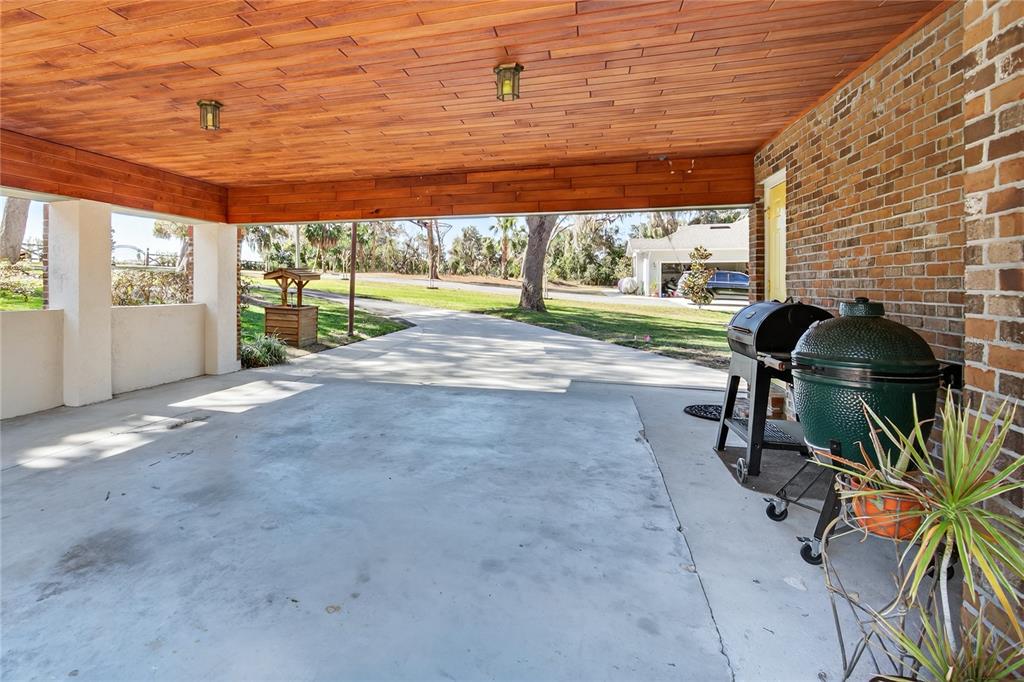 17025 Peru Road Umatilla, FL 32784 - Photo 57 of 73 a view of a porch with furniture and garden