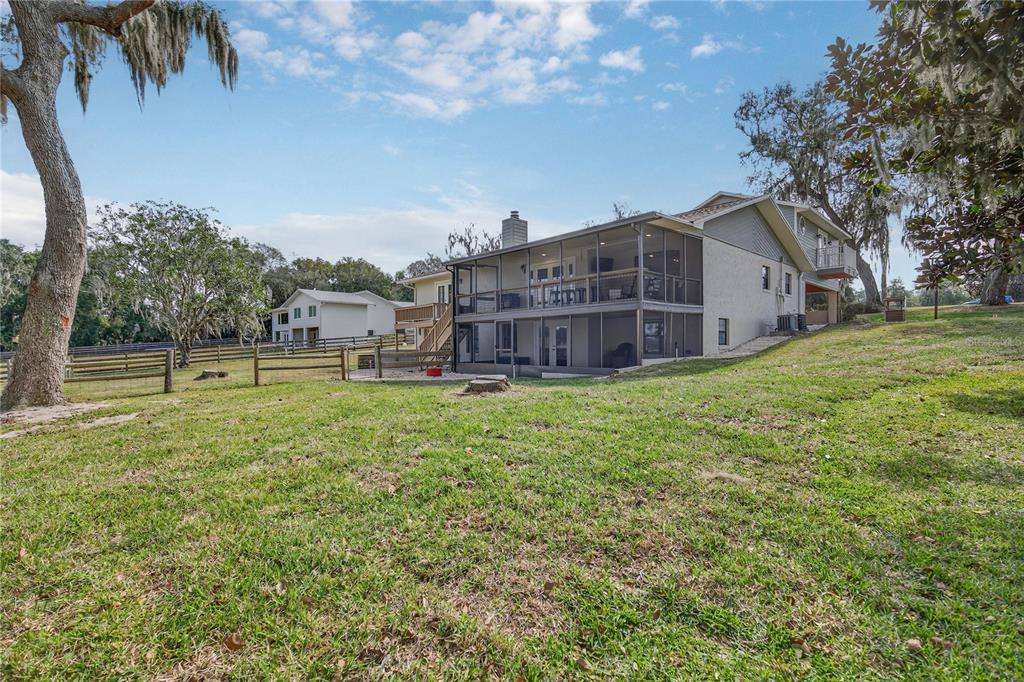 17025 Peru Road Umatilla, FL 32784 - Photo 6 of 73 a view of a house with a big yard and large trees