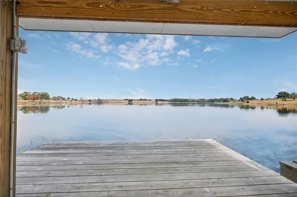 a living room with stainless steel appliances kitchen island granite countertop a living room and couches with wooden floor