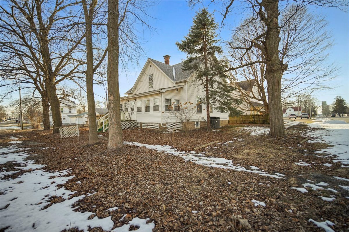410 North Main Street Le Roy, IL 61752 - Photo 19 of 23 a view of a white house next to a road with large trees