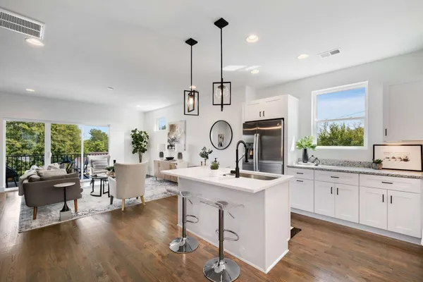 a view of center island with wooden cabinets and couch
