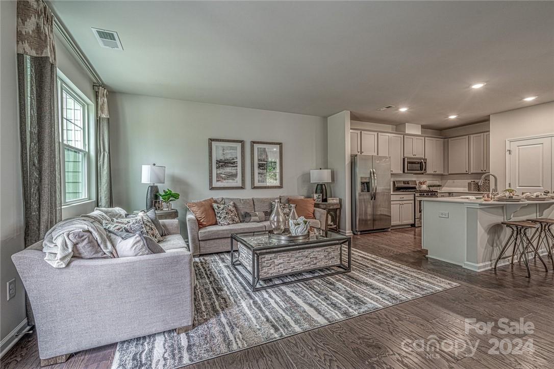 6051 Chelsea Oaks Ridge, Unit 2071 Tega Cay, SC 29708 - Photo 3 of 12 a living room with furniture and a large window