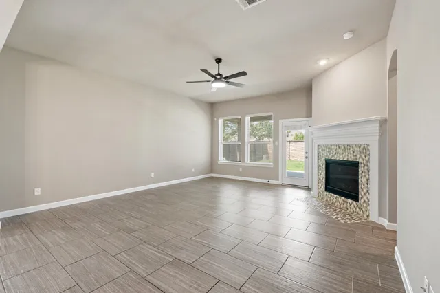 an empty room with fan and windows