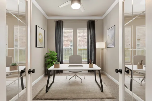 a living room with furniture and a potted plant