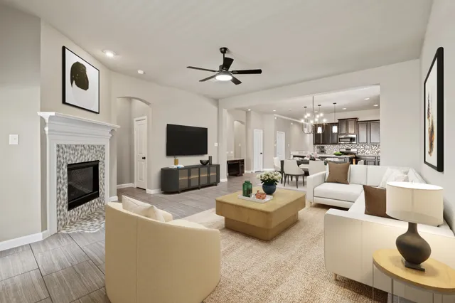 a living room with furniture a fireplace and a flat screen tv