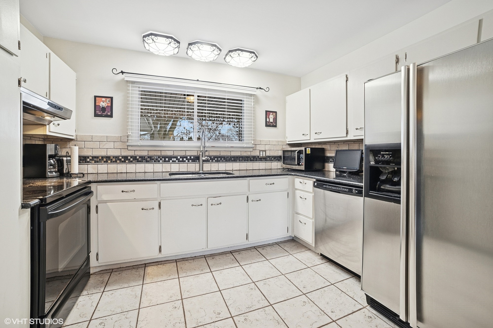 720 Alcoa Lane Hoffman Estates, IL 60169 - Photo 5 of 23 a kitchen with stainless steel appliances granite countertop a stove a sink and a refrigerator