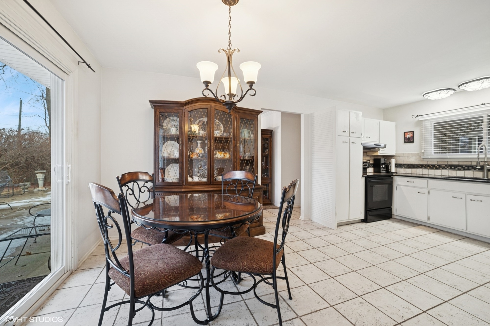 720 Alcoa Lane Hoffman Estates, IL 60169 - Photo 6 of 23 a dining room with furniture a chandelier and wooden floor