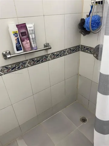 a bathroom with a shower and a sink