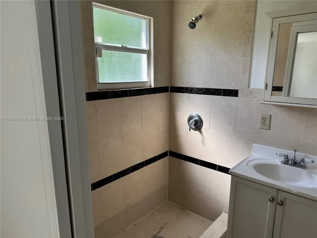 a bathroom with a sink and a window