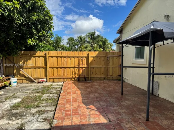 a view of outdoor space with wooden fence