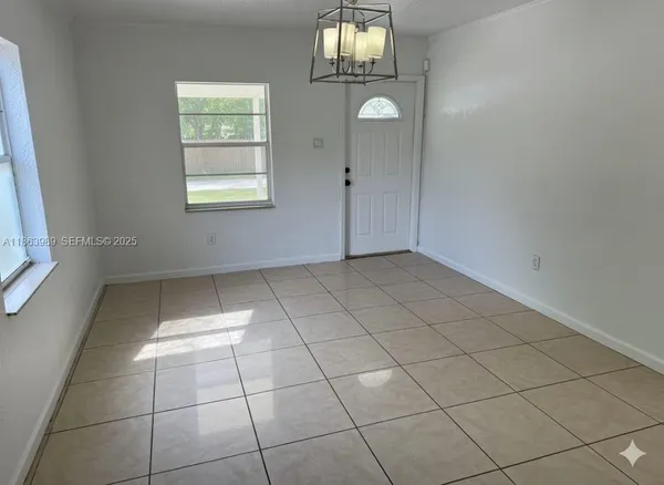 an empty room with windows and entrance