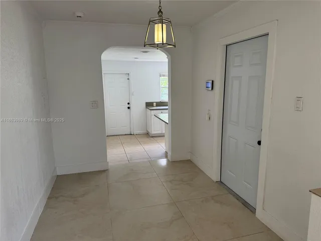 a view of an empty room and a window and fire place