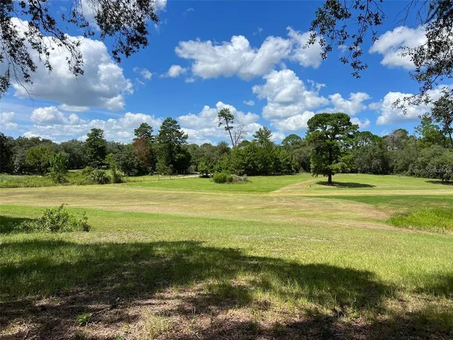 a view of swimming pool is middle in the middle of a yard