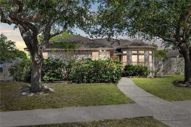 a front view of a house with a garden