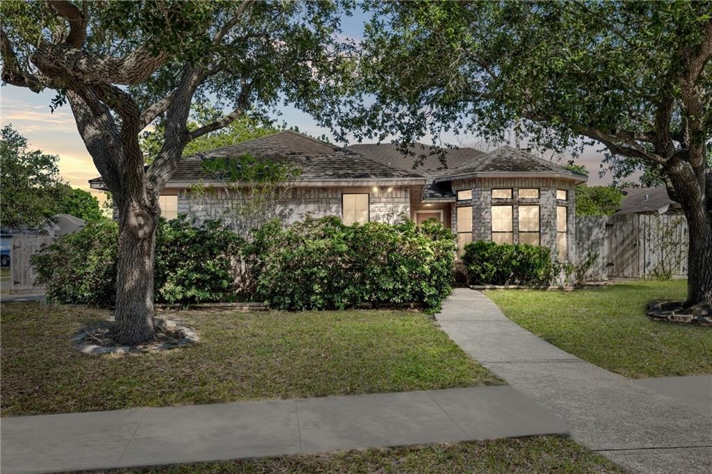 a front view of a house with a garden