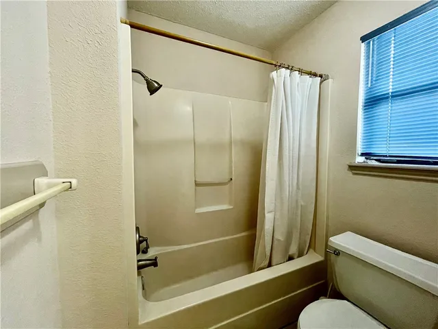 a bathroom with a shower and a toilet