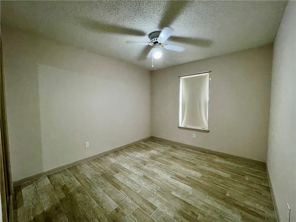 7302 Twilight Ridge Drive Corpus Christi, TX 78413 - Photo 16 of 22 en view of an empty room and chandelier fan