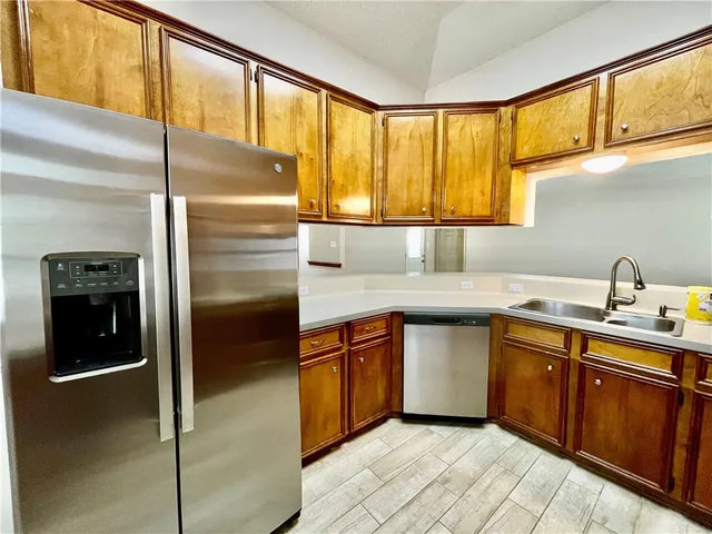 a kitchen with stainless steel appliances granite countertop a sink and cabinets