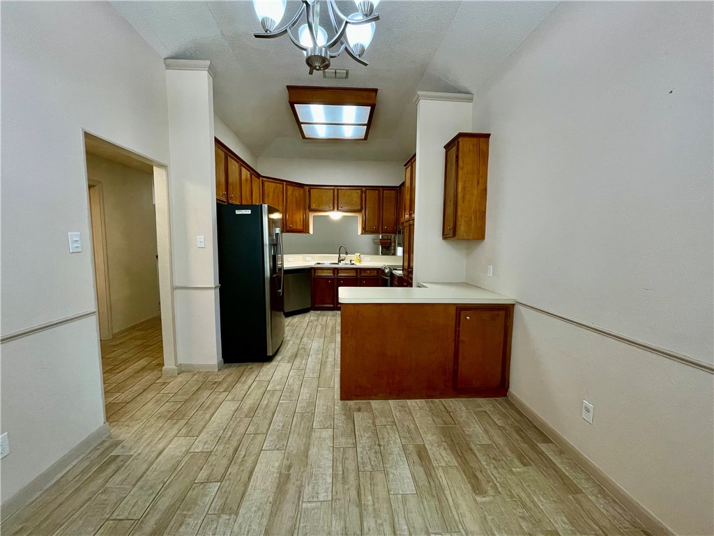 7302 Twilight Ridge Drive Corpus Christi, TX 78413 - Photo 6 of 22 a view of a kitchen with a refrigerator and a microwave