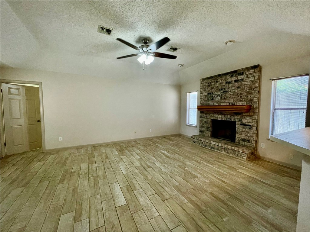 7302 Twilight Ridge Drive Corpus Christi, TX 78413 - Photo 8 of 22 a view of empty room with wooden floor and fireplace