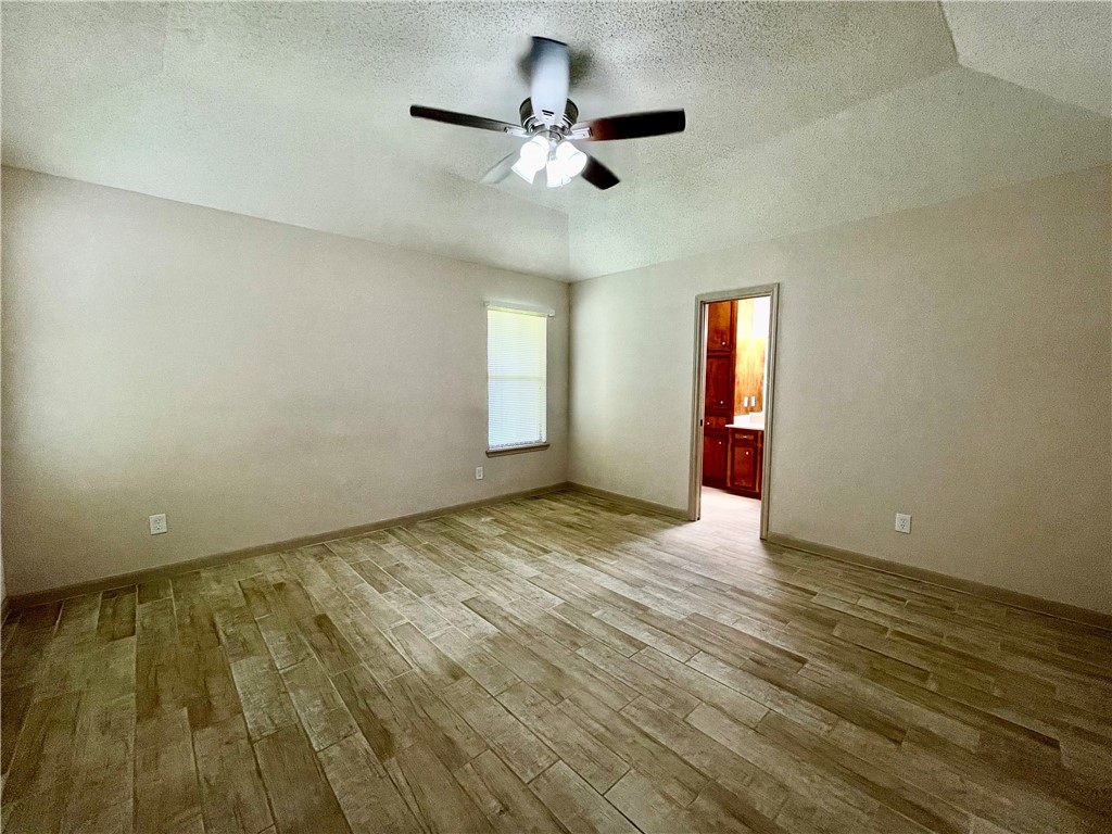 7302 Twilight Ridge Drive Corpus Christi, TX 78413 - Photo 10 of 22 wooden floor in an empty room with a window