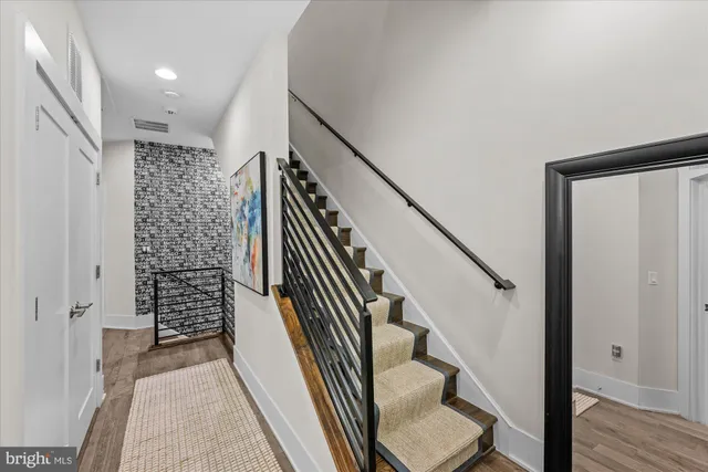 a bathroom with a sink mirror and toilet