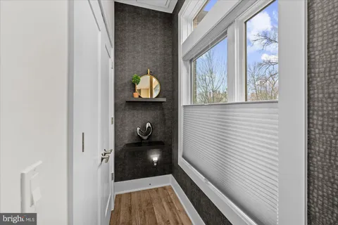 a bathroom with a sink mirror and toilet