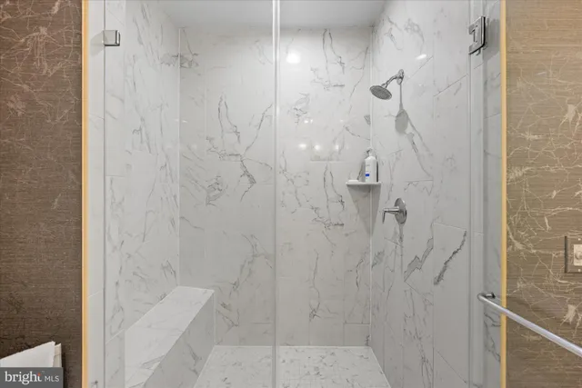 a bathroom with a double vanity sink a mirror and a shower