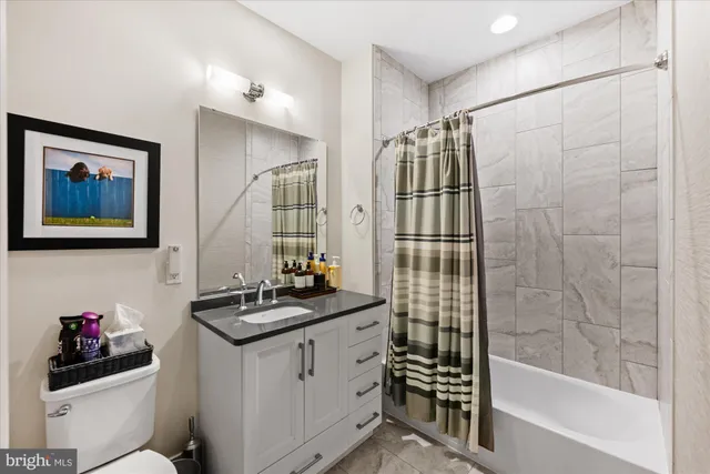 a bedroom with a bed furniture and a large window