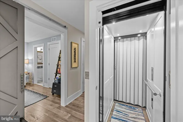 a room with painting on the wall and a window