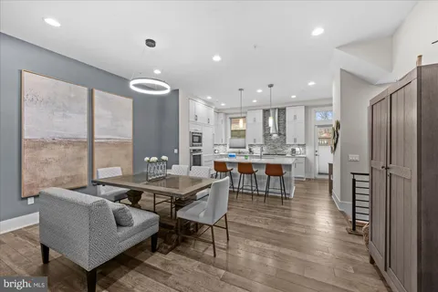 a living room with furniture and kitchen view
