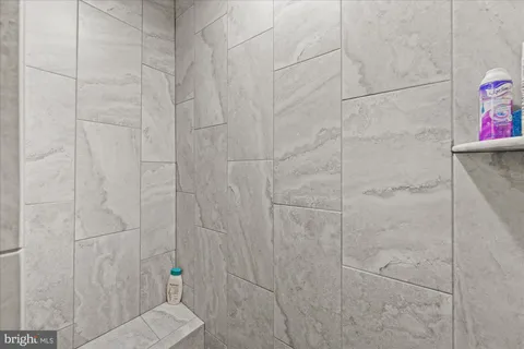 a bathroom with a granite countertop sink mirror vanity and toilet