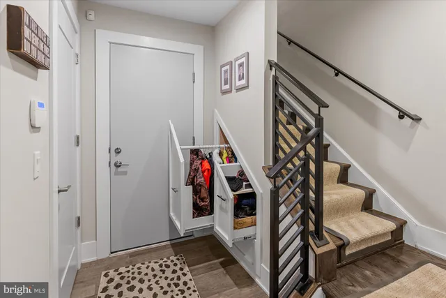 a view of entryway with stairs and wooden floor