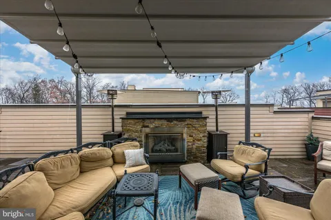 a view of a patio with a table and chairs and floor to ceiling window and wooden floor