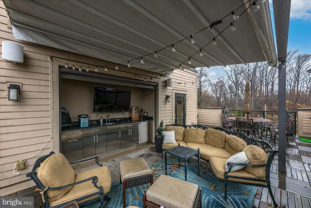 a view of a patio with couches table and chairs and potted plants