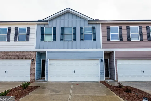 a front view of a house with a garage