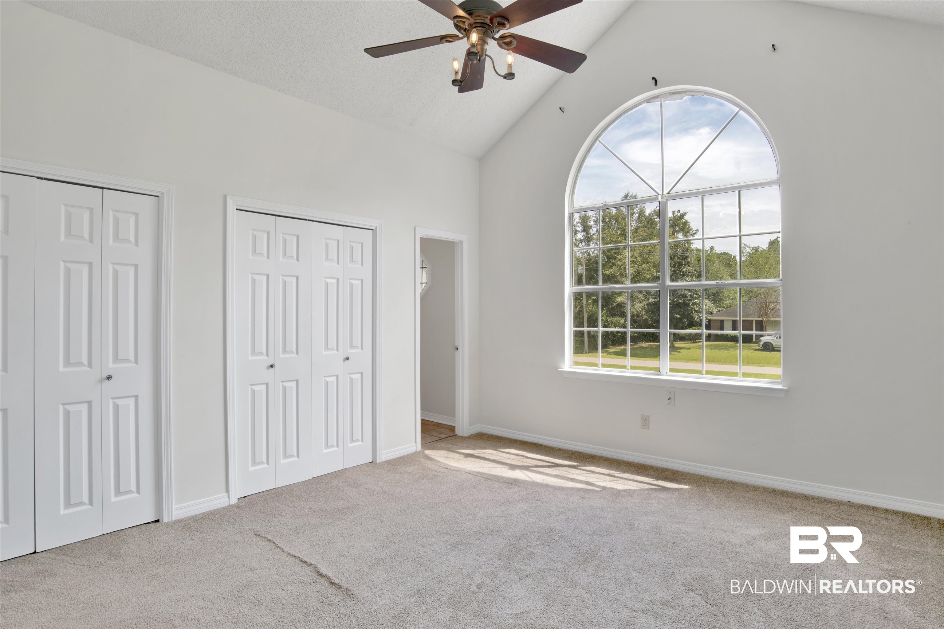 5480 Country Club Boulevard Theodore, AL 36582 - Photo 24 of 36 Unfurnished bedroom with lofted ceiling, two closets, ceiling fan, and carpet