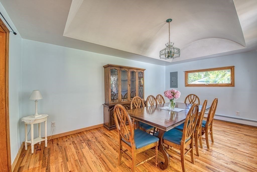 81 Errol Road Brockton, MA 02302 - Photo 23 of 31 a dining room with furniture a chandelier and wooden floor