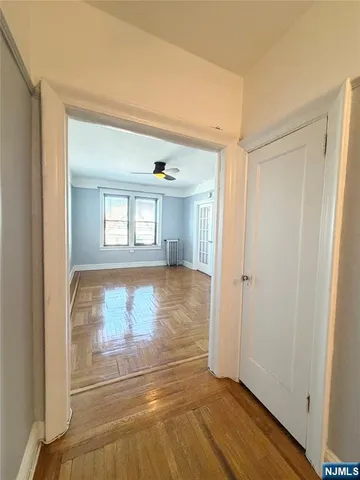 a view of walk in closet with wooden floor