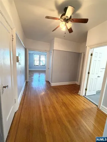 a view of hallway with wooden floor